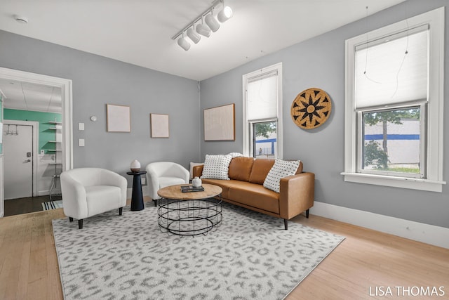 1000 Garfield Ave NW, Grand Rapids, MI 49504 - living room with wood finished floors, rail lighting, and baseboards