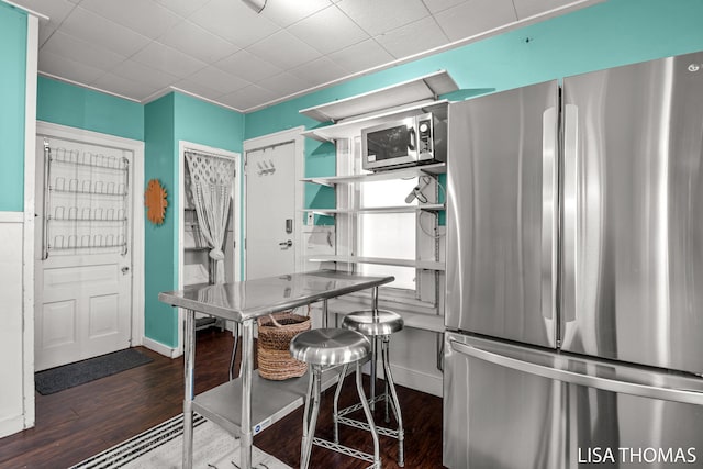 1000 Garfield Ave NW, Grand Rapids, MI 49504 - kitchen with appliances with stainless steel finishes, wood finished floors, and baseboards