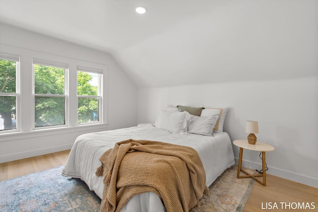 1000 Garfield Ave NW, Grand Rapids, MI 49504 - bedroom with multiple windows, vaulted ceiling, wood finished floors, baseboards, and recessed lighting