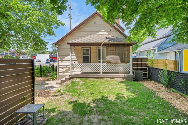 1000 Garfield Ave NW, Grand Rapids, MI 49504 - rear view of house featuring a sunroom and a chimney