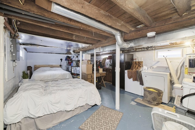 513 1st St, Manistee, MI 49660 - bedroom featuring washer and dryer, electric panel, finished concrete flooring, and electric water heater