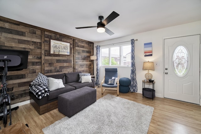 513 1st St, Manistee, MI 49660 - living room featuring a ceiling fan, light wood finished floors, and baseboards
