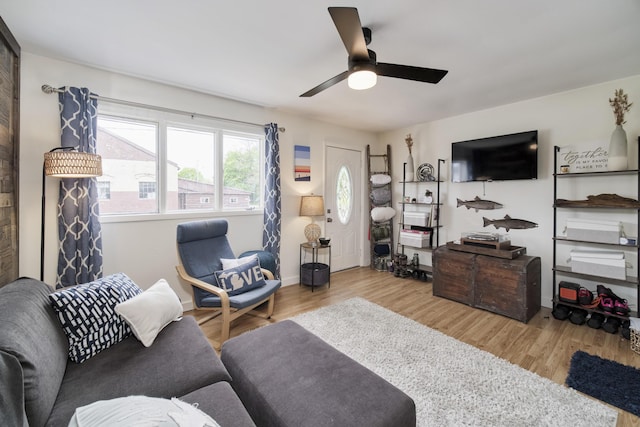 513 1st St, Manistee, MI 49660 - living room with wood finished floors, ceiling fan, and baseboards