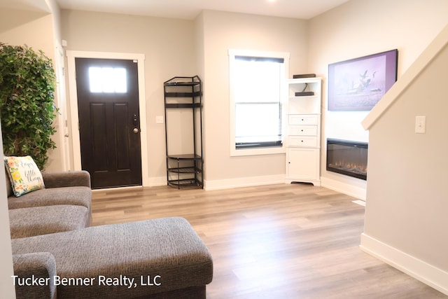 239 Monroe Ave, Muskegon, MI 49441 - foyer featuring wood finished floors, healthy amount of natural light, and baseboards