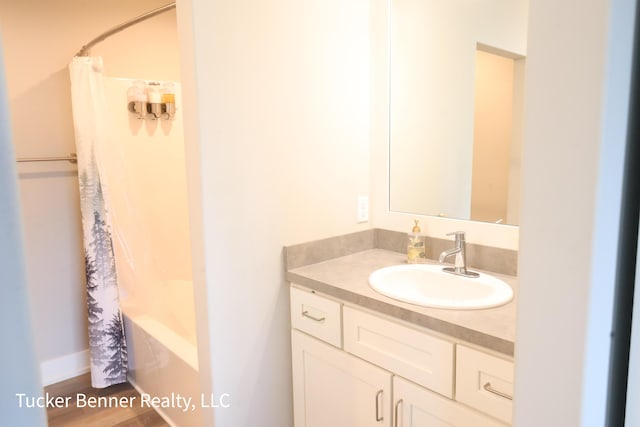 239 Monroe Ave, Muskegon, MI 49441 - full bathroom featuring vanity, shower / tub combo with curtain, and wood finished floors