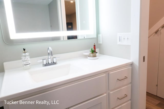 239 Monroe Ave, Muskegon, MI 49441 - bathroom featuring vanity and wood finished floors