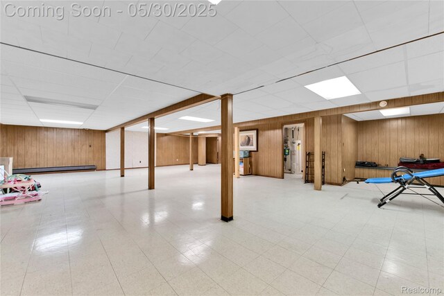 11030 Olive St, Warren, MI 48093 - finished below grade area with wooden walls, a drop ceiling, baseboard heating, and light flooring