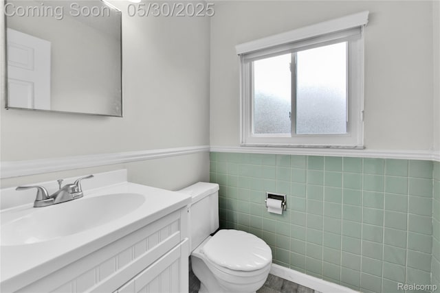 11030 Olive St, Warren, MI 48093 - bathroom featuring toilet, vanity, tile walls, and a wainscoted wall