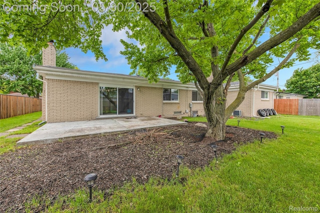 11030 Olive St, Warren, MI 48093 - back of house featuring a chimney, brick siding, and a patio area