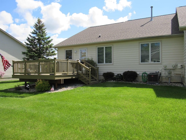 6044 Belmont Ct, Grand Blanc, MI 48439 - rear view of property featuring cooling unit, a deck, a lawn, and roof with shingles