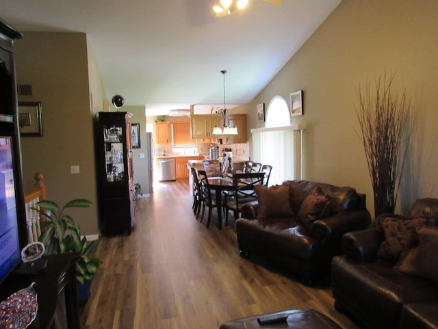 6044 Belmont Ct, Grand Blanc, MI 48439 - living area featuring a chandelier, lofted ceiling, and wood finished floors