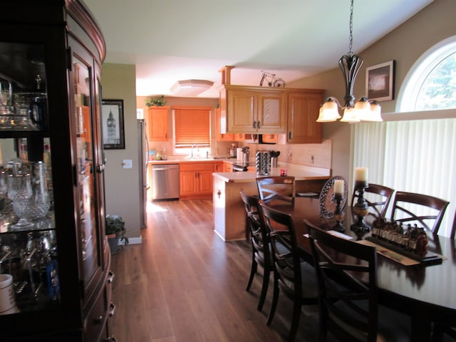 6044 Belmont Ct, Grand Blanc, MI 48439 - dining space with lofted ceiling, wood finished floors, and a chandelier