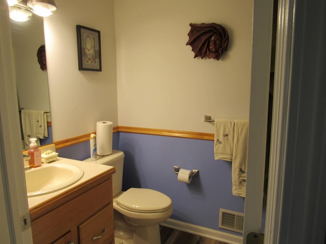 6044 Belmont Ct, Grand Blanc, MI 48439 - bathroom with vanity, toilet, and wood finished floors
