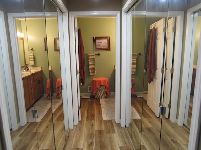 6044 Belmont Ct, Grand Blanc, MI 48439 - corridor with a sink and light wood-style floors