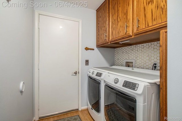155 Woodridge Ct, Oxford, MI 48371 - washroom featuring cabinet space, washer and dryer, light wood-type flooring, and baseboards