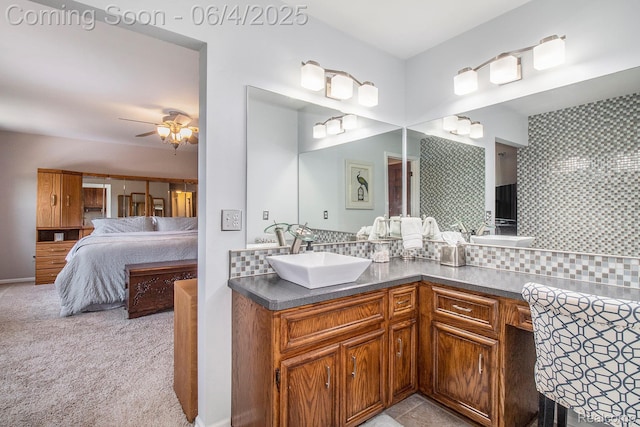 155 Woodridge Ct, Oxford, MI 48371 - ensuite bathroom with double vanity, decorative backsplash, and ceiling fan