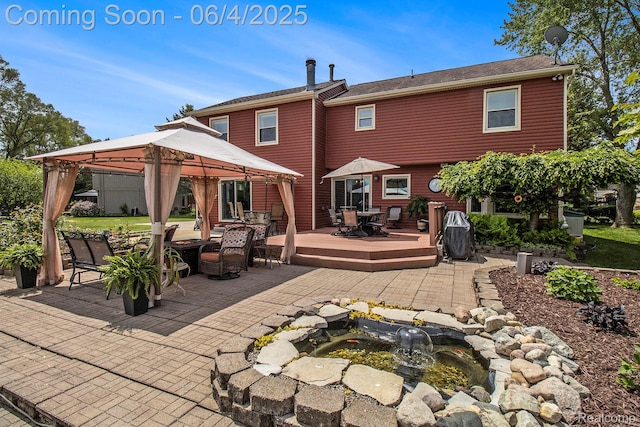 155 Woodridge Ct, Oxford, MI 48371 - rear view of property with a gazebo, outdoor dining space, a deck, and a patio area