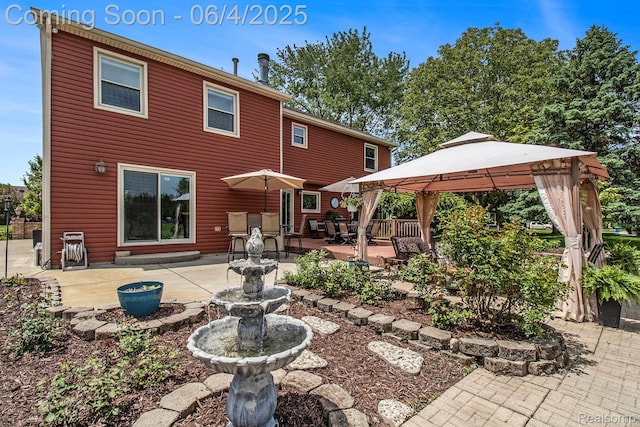 155 Woodridge Ct, Oxford, MI 48371 - rear view of house with a gazebo and a patio