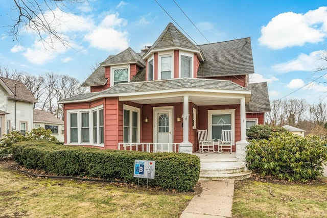 724 Wilson St, South Haven, MI 49090 - victorian-style house featuring roof with shingles, covered porch, and a front yard