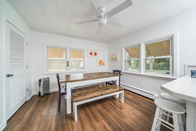 724 Wilson St, South Haven, MI 49090 - dining space featuring a baseboard heating unit, radiator heating unit, dark wood-type flooring, and a ceiling fan