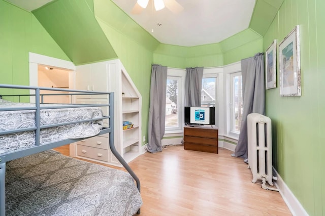 724 Wilson St, South Haven, MI 49090 - bedroom featuring radiator, light wood-style floors, lofted ceiling, and ceiling fan
