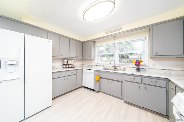 11523 Jenny Dr, Warren, MI 48093 - kitchen featuring white appliances, gray cabinets, a sink, and light wood-style floors