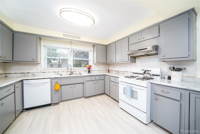 11523 Jenny Dr, Warren, MI 48093 - kitchen with white appliances, gray cabinetry, under cabinet range hood, and a sink