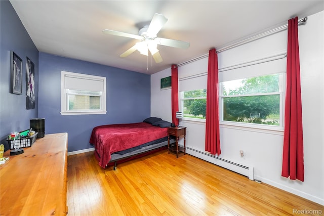 11523 Jenny Dr, Warren, MI 48093 - bedroom featuring baseboard heating, wood finished floors, and ceiling fan