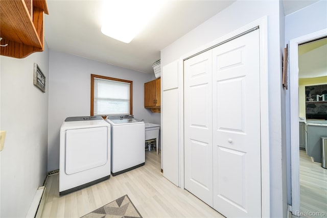 11523 Jenny Dr, Warren, MI 48093 - laundry room featuring washer and dryer, cabinet space, a baseboard radiator, and light wood-type flooring