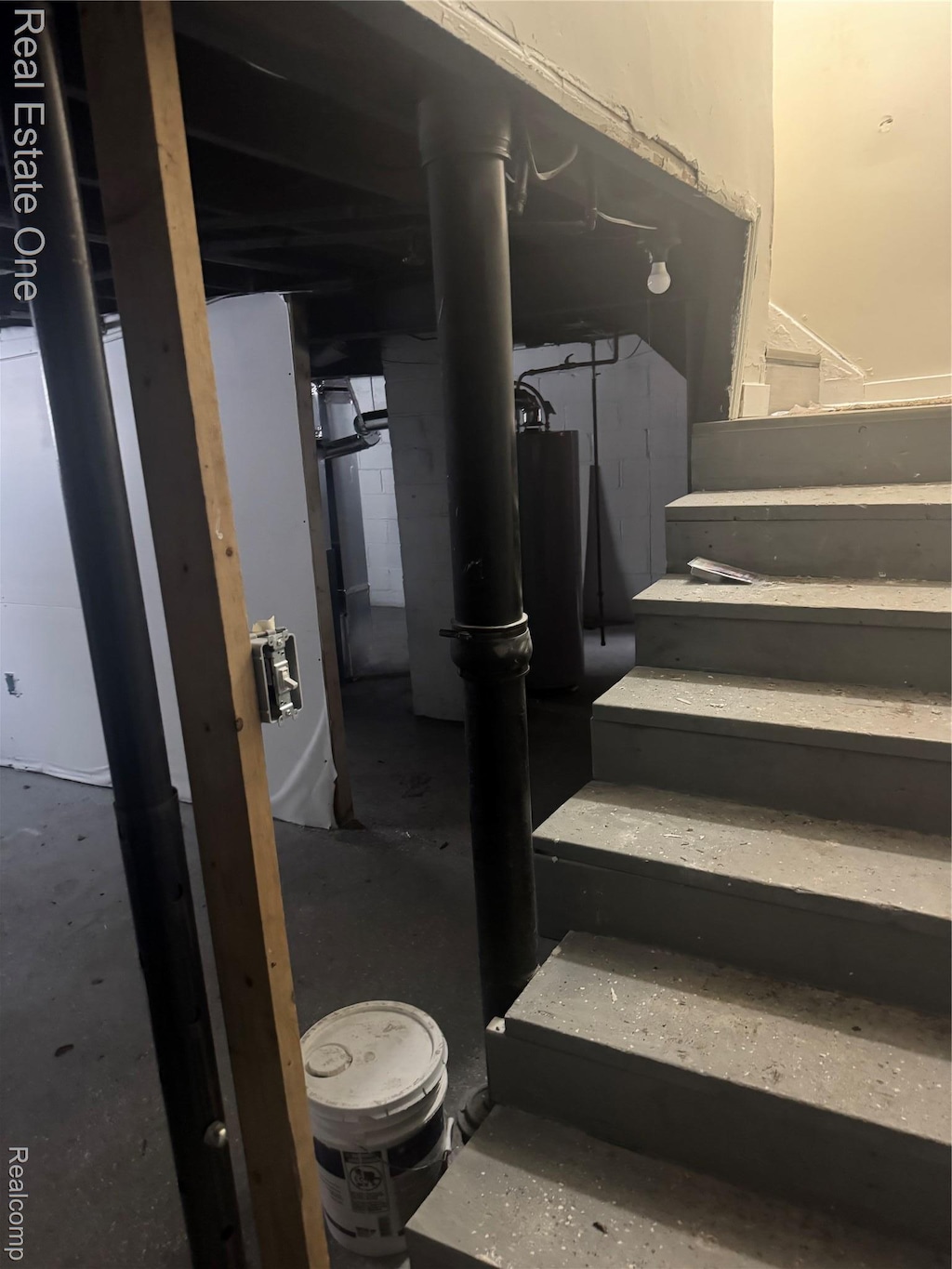 16718 Fenmore St, Detroit, MI 48235 - staircase with concrete flooring and water heater