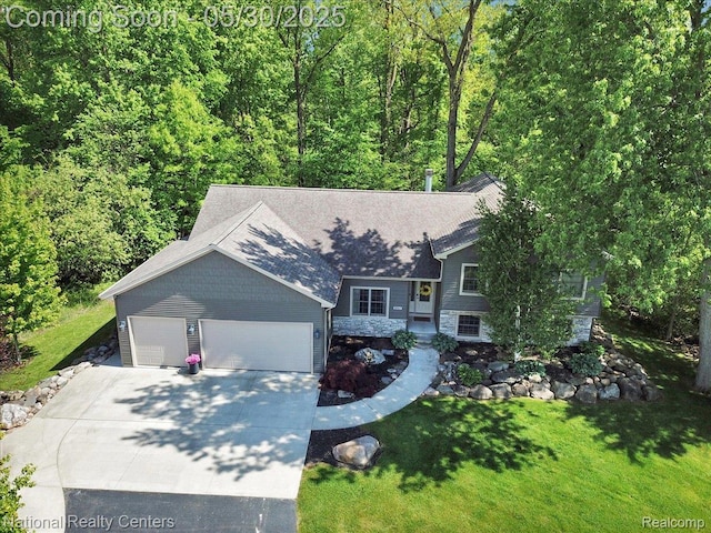 5257 Brookshire Dr, Almont, MI 48003 - view of front of property with driveway, a garage, a front yard, roof with shingles, and a forest view