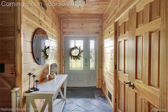 5257 Brookshire Dr, Almont, MI 48003 - entrance foyer featuring wood ceiling, wood walls, and stone tile flooring