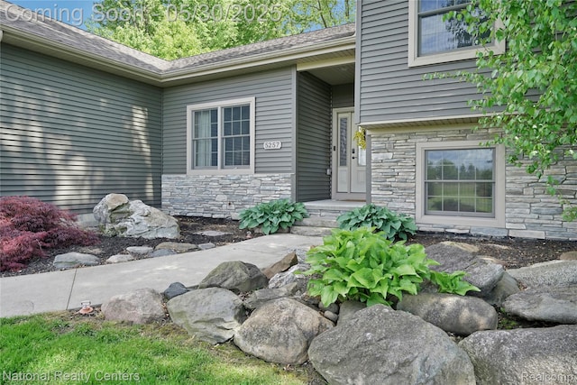 5257 Brookshire Dr, Almont, MI 48003 - view of exterior entry featuring stone siding