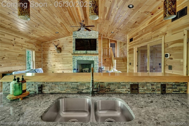 5257 Brookshire Dr, Almont, MI 48003 - kitchen featuring a sink, a ceiling fan, wood ceiling, lofted ceiling, and stone countertops