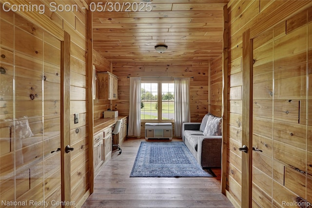 5257 Brookshire Dr, Almont, MI 48003 - sitting room featuring wood walls, wooden ceiling, and light wood-type flooring