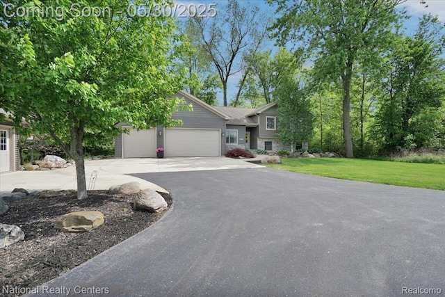 5257 Brookshire Dr, Almont, MI 48003 - split level home featuring asphalt driveway, a front lawn, and a garage