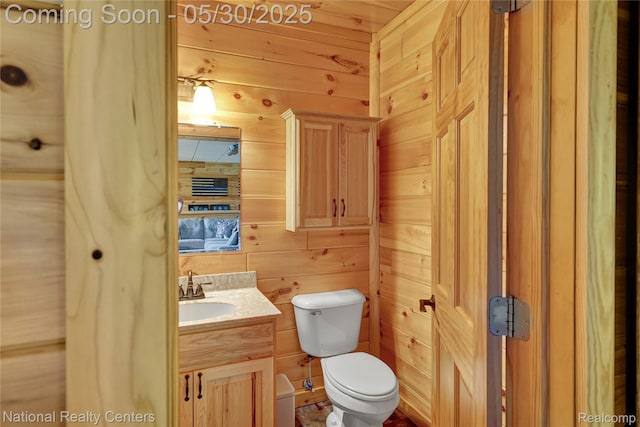 5257 Brookshire Dr, Almont, MI 48003 - bathroom with wooden walls, toilet, and vanity