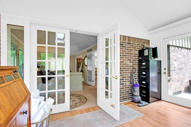 1330 Kings Carriage Rd, Grand Blanc, MI 48439 - doorway with french doors, healthy amount of natural light, wood finished floors, vaulted ceiling, and crown molding