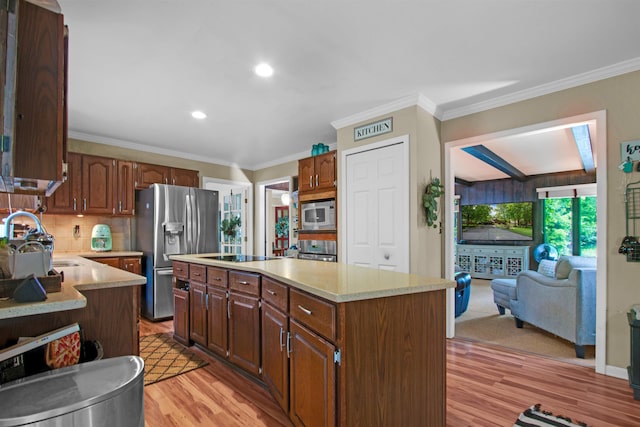 1330 Kings Carriage Rd, Grand Blanc, MI 48439 - kitchen with a sink, stainless steel refrigerator with ice dispenser, light countertops, built in microwave, and crown molding