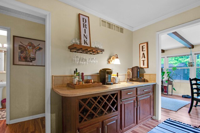 1330 Kings Carriage Rd, Grand Blanc, MI 48439 - indoor dry bar with light wood finished floors and crown molding