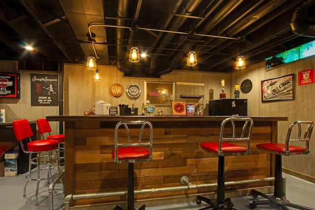 1330 Kings Carriage Rd, Grand Blanc, MI 48439 - indoor bar with wooden walls and finished concrete flooring