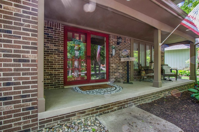 1330 Kings Carriage Rd, Grand Blanc, MI 48439 - property entrance with brick siding, a porch, and french doors