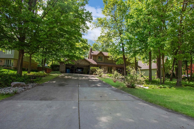 1330 Kings Carriage Rd, Grand Blanc, MI 48439 - obstructed view of property featuring concrete driveway, a chimney, and a front lawn