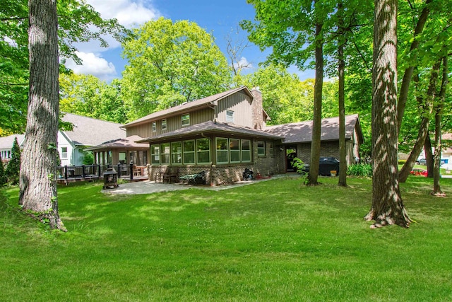 1330 Kings Carriage Rd, Grand Blanc, MI 48439 - rear view of property with a patio area, a lawn, and brick siding