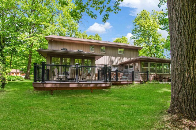 1330 Kings Carriage Rd, Grand Blanc, MI 48439 - rear view of house with a sunroom, a yard, and a wooden deck