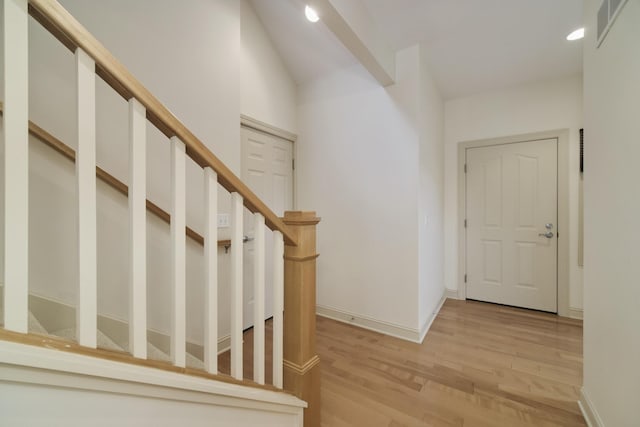 70 Spinnaker Dr, Manistee, MI 49660 - entrance foyer with light wood-style floors, baseboards, recessed lighting, and stairway