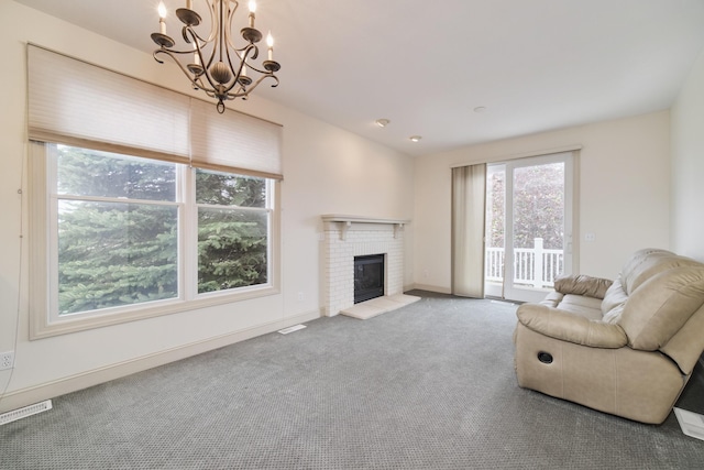 70 Spinnaker Dr, Manistee, MI 49660 - carpeted living area with a chandelier, a fireplace, and baseboards