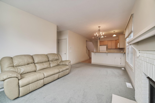 70 Spinnaker Dr, Manistee, MI 49660 - living area with light carpet, a chandelier, baseboards, and a brick fireplace