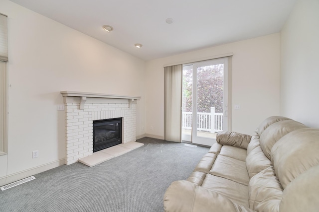 70 Spinnaker Dr, Manistee, MI 49660 - living area featuring carpet floors, a brick fireplace, and baseboards