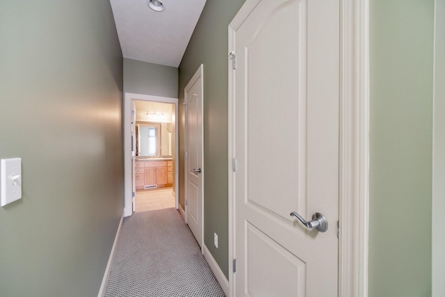 70 Spinnaker Dr, Manistee, MI 49660 - hallway featuring carpet flooring and baseboards